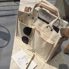 a white bag with sunglasses on top of it