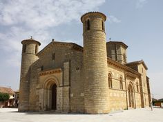 an old stone church with two towers