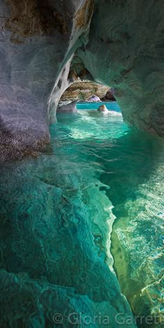 the water is crystal blue and green in this cave like area that looks like it could be underwater