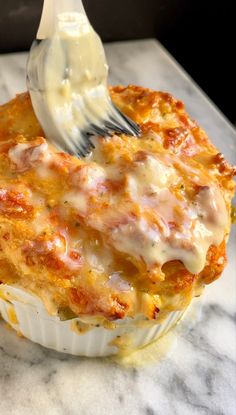 a close up of a food entree with a fork stuck in the muffin