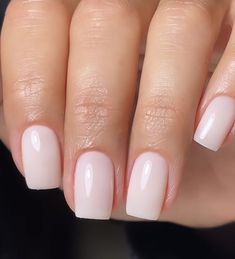 a woman's hand with white manies and pink nail polish on her nails