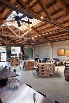 an empty restaurant with wooden tables and chairs