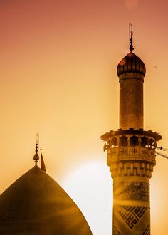 the sun is setting behind a tall building with a dome on it's roof