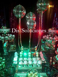 disco balls and cupcakes are on display at a party with green, white and red lights