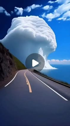 an animated image of a large cloud coming out of the sky over a road next to the ocean