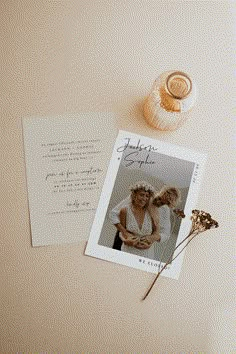 an image of a couple and their dog on top of a table with some flowers