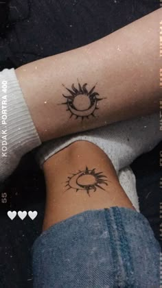 two people with tattoos on their legs and one is holding the other's arm