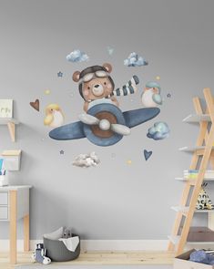 a child's room with a teddy bear flying on an airplane