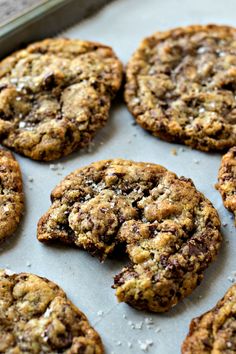 chocolate chip cookies sitting on top of a baking sheet