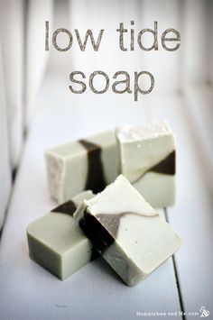 three pieces of soap sitting on top of a white table with the words low tide soap