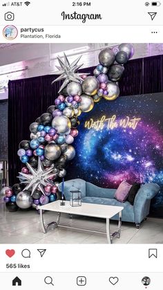 a living room filled with furniture and balloons in the shape of a star, surrounded by stars