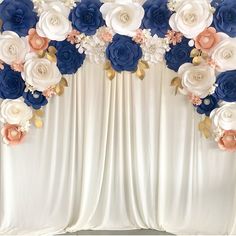 the backdrop is decorated with blue, white and pink flowers on silk draping