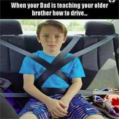 a young boy sitting in the back seat of a car