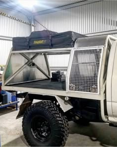 the truck is parked in the garage with its bed on it's flatbed