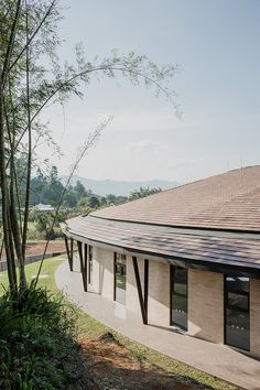 the roof of a building with trees and grass around it