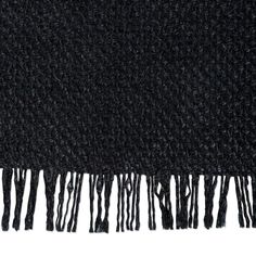 the black scarf has fringes on it