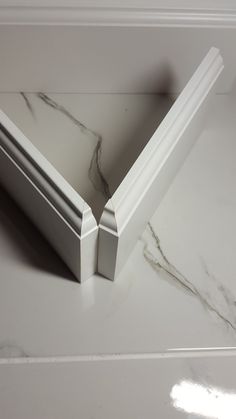 a marble counter top with white trim on it