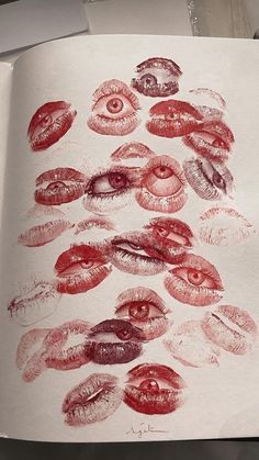 an open book with many different images of lips on the pages and in red ink