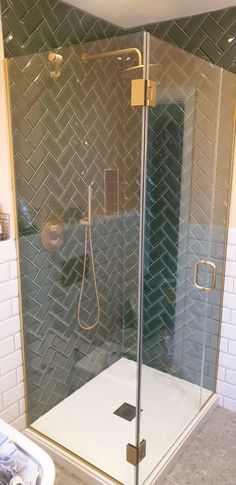 a walk in shower sitting inside of a bathroom