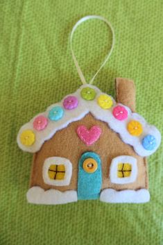 a gingerbread house ornament with buttons on it