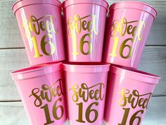 six pink cups with gold numbers and the words sweet sixteen are stacked on top of each other