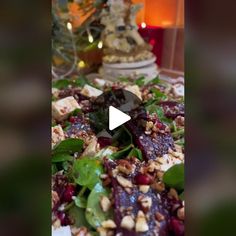 a salad with spinach, nuts and cranberries is shown in this video