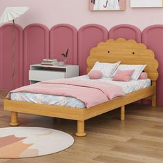 a bedroom with pink walls and wooden bed frame in the center, along with an area rug on the floor