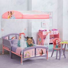 She'll drift off to sleep like a true Disney Princess in this canopy toddler bed by Delta Children. © Disney She'll drift off to sleep like a true Disney Princess in this canopy toddler bed by Delta Children. © Disney Easy assembly Uses a standard crib mattress (sold separately) Features two attached guardrails with low to the ground design at ideal kid-sized height Enables safe and easy access in and out of bed Colorful Disney Princess canopy creates a dream bedroom for your little one JPMA cer Princess Toddler Bed, Disney Princess Bedding, Princess Canopy, Disney Princess Theme, Ground Design, Big Kid Bed, Princess Bed, Crib Toddler Bed, Toddler Beds