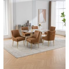 a dining room table with six chairs and a rug on the floor in front of it