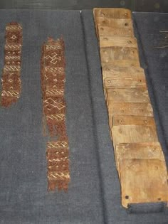 three pieces of cloth are laying on the floor next to some wood planks that have been placed together