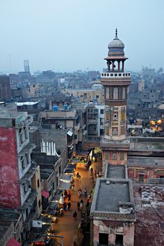 an aerial view of a city with lots of buildings and people walking on the street