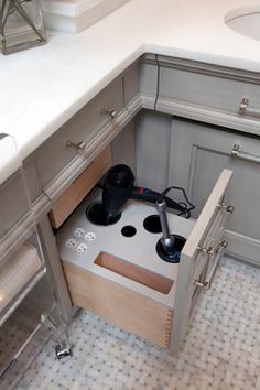 an open drawer in the middle of a kitchen