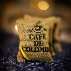 a coffee bag with the words cafe de colombre on it sitting on a bed