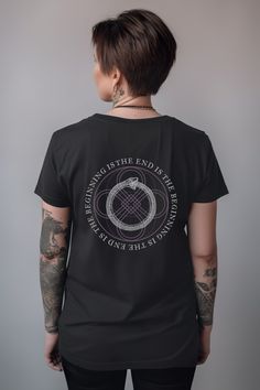 Embrace your inner power with the Ouroboros Occult Shirt. Perfect for all modern mystics and spiritual seekers, it is crafted from 100% breathable cotton, seamlessly blending esotericism with modern comfort. Elevate your everyday style with this unique addition to your wardrobe staples.Choose from a variety of plus sizes up to 3XL for a roomy fit, or size up for an oversized look.Surprise any of your mystical friends with a gift they would love! Breathable 100% cotton for all day comfort Retail The End Is The Beginning, Ouroboros Jewelry, Alchemy Shirt, Black Gothic Cotton T-shirt, Gothic Cotton T-shirt With Graphic Print, Black Horror T-shirt With Skull Print, Occult Fashion, Occult Symbols, Inner Power