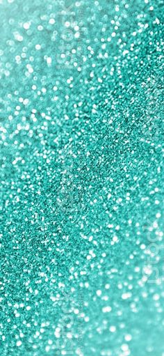 green glitter textured background with white and black dots on the bottom, as well as blue