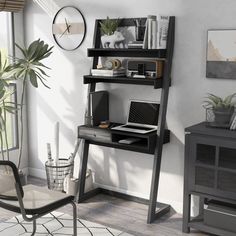 a computer desk with a laptop on top of it next to a ladder book shelf