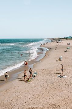 many people are on the beach and in the water