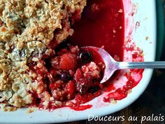 a close up of a plate of food with berries and crumbs on it