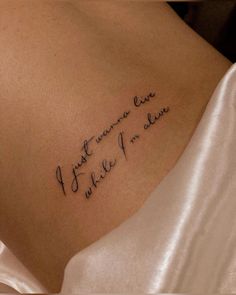 the back of a woman's shoulder with writing on it