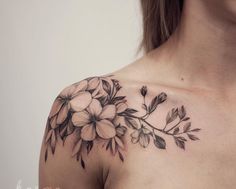 a woman with a flower tattoo on her shoulder