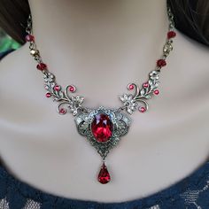 "This vintage medieval styled crystal necklace features luscious Scarlet colored Austrian crystals with nice crisp facets and brass embellishments.  Rich with elegance, this piece would be perfect for a moonlit date night, medieval fair and countless formal events. The necklace focal point, along with the drop crystal, measures approximately 2\" long and 1-1/2\" wide. The brass chain is 18\" long and can be shortened by hooking the lobster clasp onto any of the 4x6mm cable chain links for a cust Vampire Jewelry Necklaces, Necklace Vampire, Vamp Goth, Medieval Necklace, Vampire Necklace, Vampire Jewelry, Medieval Fair, Red Crystal Necklace, Gothic Medieval