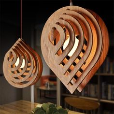 a wooden light fixture hanging from a ceiling in a living room next to a potted plant