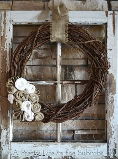 a wreath is hanging on an old window