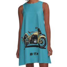 a woman wearing a blue dress with an image of a motorbike on it