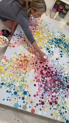 a woman working on an art project with circles