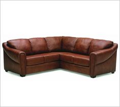 a brown leather sectional sofa with rounded back and arm rests on an isolated white background