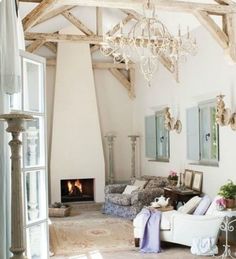 a living room filled with furniture and a fire place in the middle of a room