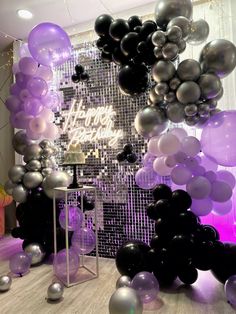 a room filled with balloons and confetti on the wall next to a mirror