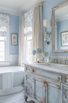 a bathroom with blue walls and white fixtures