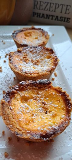 three pastries sitting on top of a white plate